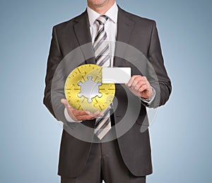 Man hold empty card and jigsaw puzzle sphere