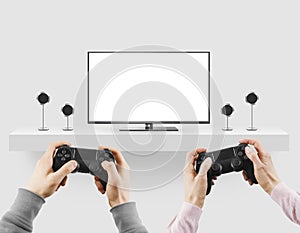 Man hold gamepad in hands in front of blank tv screen mock up pl photo