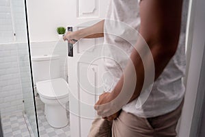 Man hold his genitals to pee photo