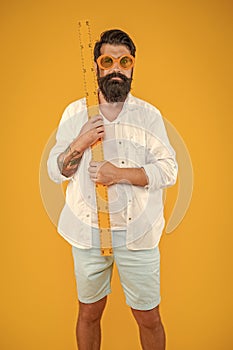 man hold measuring ruler isolated on yellow. man hold measuring ruler in studio.