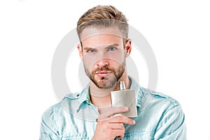 Man hold perfume bottle. Bearded man with deodorant isolated on white background. Fashion cologne bottle. Hygiene and