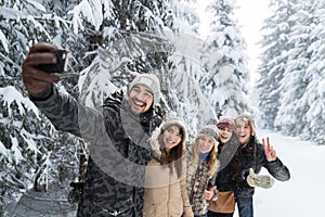 Man Hold Smart Phone Camera Taking Selfie Photo Friends Smile Snow Forest Young People Group Outdoor