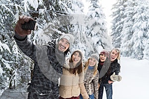 Man Hold Smart Phone Camera Taking Selfie Photo Friends Smile Snow Forest Young People Group Outdoor