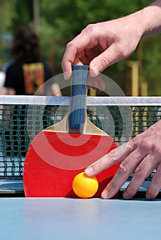 Man hold the tennis racket on pingpong table