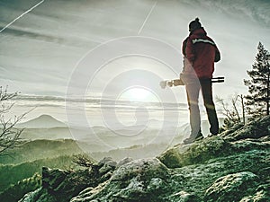 Man hold tripod. Hiker admiring stunning mountain range