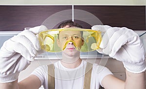 Man hold yellow safety glasses photo