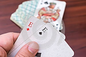 Man holding aces and trumps in his hands in a card game