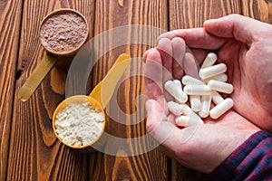 Man holding amino acid capsules