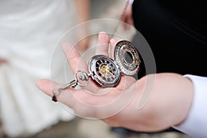 A man holding an antique pocketwatch