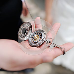 A man holding an antique pocketwatch