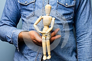 Man holding artist's dummy