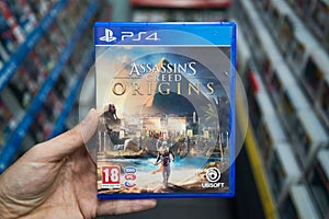 Man holding Assassin`s creed Origins videogame