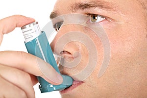 Man holding asthma medicine inhaler