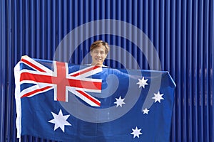 The man is holding Australia fabric flag in his hands