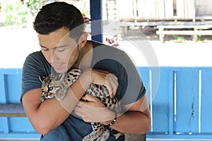 Man holding baby wild feline photo