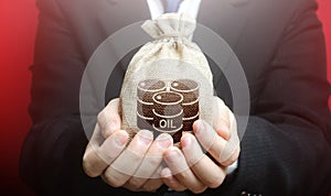 A man is holding a bag with oil barrels. Offer the purchase of oil and futures at competitive price, discounts and bonuses. photo