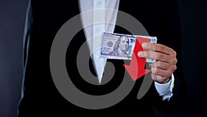 Man holding banknotes, dollar falling, financial forecast, economic crisis