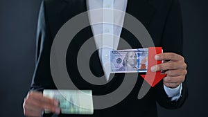 Man holding banknotes, dollar falling relative to russian ruble, stock market