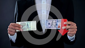 Man holding banknotes, dollar falling relative to russian ruble, stock market