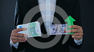 Man holding banknotes, dollar growing relative to euro, stock market, exchange