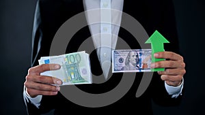 Man holding banknotes, dollar growing relative to euro, stock market, exchange