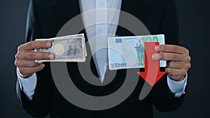 Man holding banknotes, euro falling relative to japanese yen, financial forecast
