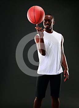 Man holding a basketball on his finger