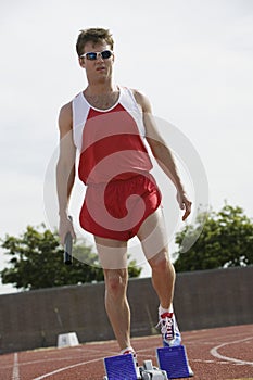 Man Holding Baton On Racing Track