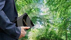 Man holding bible in his hand. Concept for faith, spirituality and religion.