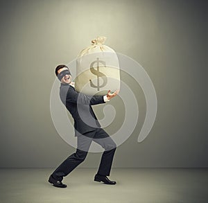 Man holding big bag with money