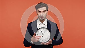 Man holding big wall clock and looking at camera