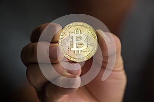 Man holding bitcoin in hand close up