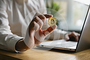 man holding bitcoin in hand. crypto buying and investment concept