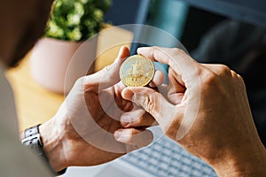 man holding bitcoin in hand. crypto buying and investment concept. blockchain and digital assets