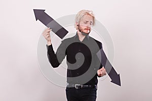 Man holding black arrows pointing left and right