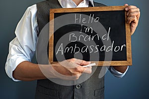 Man holding blackboard with sign I am Brand Ambassador