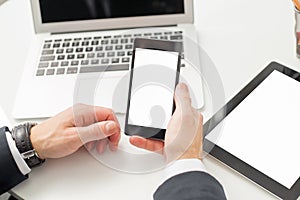Man holding blank screen smartphone at the office