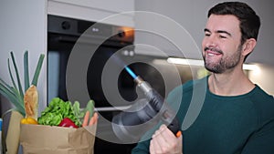 Man holding a blowtorch in the kitchen