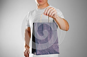 Man holding a blue gift bag. Close up. Isolated background