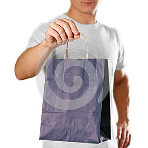 Man holding a blue gift bag. Close up. Isolated on white background