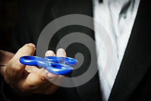 A man holding a blue spinner.