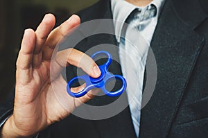 A man holding a blue spinner.