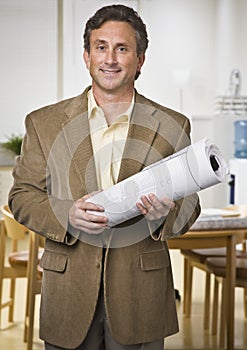 Man Holding Blueprints