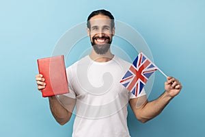Man holding book and Great Britain flag, education, learning English language.