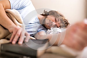 Man holding book and sleeping in bed