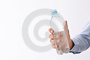 Man holding bottle of pure water on white background, closeup