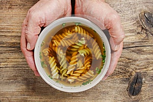 Man holding a bowl of soup.