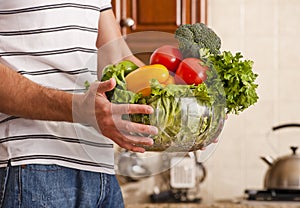 Man Holding Bowl of Vegetables