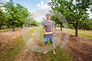 Man holding a box full of organik ripe cherries. Ingathering