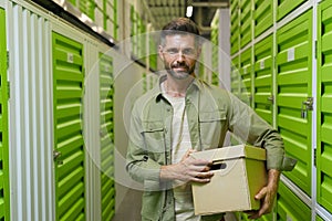 Man Holding Box in Self Storage Unit